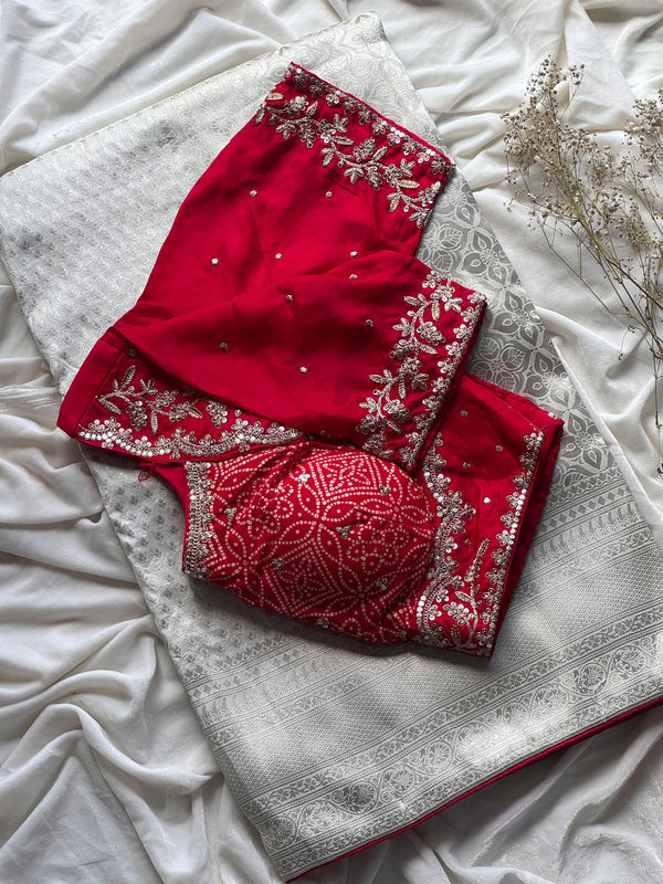 Banarasi Silk White Sari Teamed With Red Bandhej Stiched Blouse