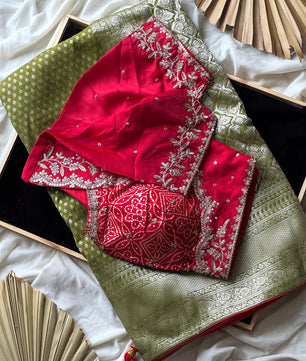 Banarasi Silk Saree In Green Teamed With Red Bandhej Stiched Blouse