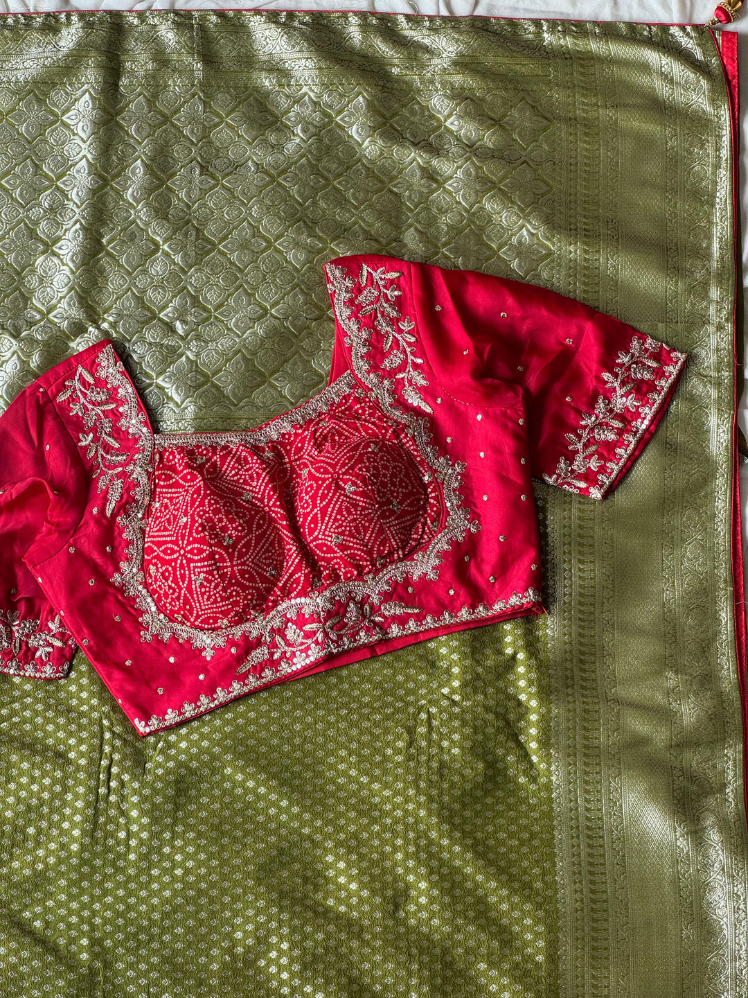 Banarasi Silk Saree In Green Teamed With Red Bandhej Stiched Blouse