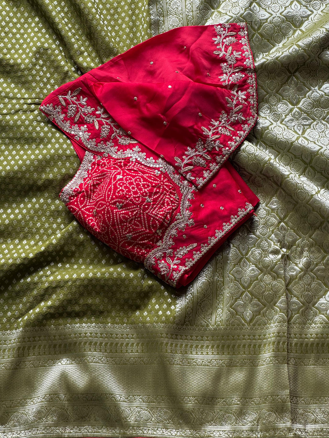 Banarasi Silk Saree In Green Teamed With Red Bandhej Stiched Blouse